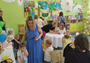 rodzice i dzieci częstują się przygotowanymi pysznościami