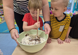 chłopiec trzyma łyżkę i miesza