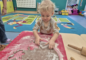 chłopiec wykrawa foremką ciasto