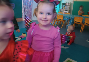 dziewczynka w różowym stroju jednorożca uśmiecha się