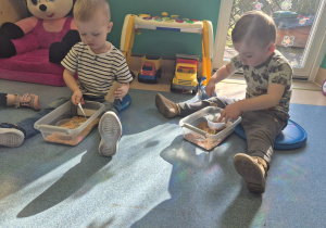 chłopcy sypią do miseczek i przez rurkę produkty