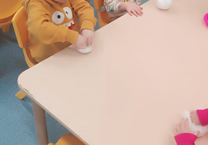 dzieci ugniatają watę w kubeczkach